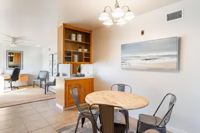 a dining room and kitchen with a table and chairs at Casa Flora -2BR- FREE Parking in Little Italy! in San Diego