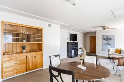 a dining room and living room with a table and chairs at Casa Flora -2BR- FREE Parking in Little Italy! in San Diego