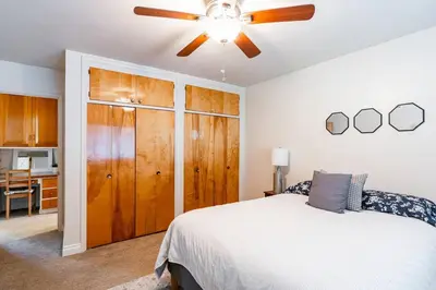 a bedroom with a bed and a ceiling fan at Casa Flora -2BR- FREE Parking in Little Italy! in San Diego