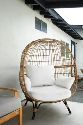 a rattan chair with white pillows on a patio at *Golden Getaway* 5 Beds / 8 Minutes to Downtown in San Diego