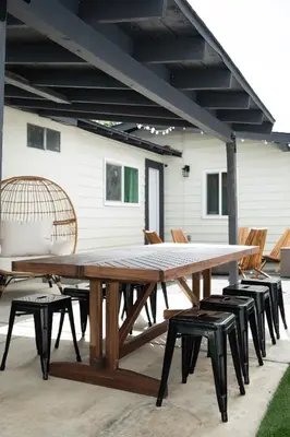 a large wooden picnic table with chairs on a patio at *Golden Getaway* 5 Beds / 8 Minutes to Downtown in San Diego