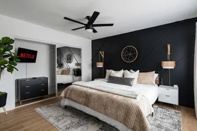 a bedroom with a bed with a black accent wall at *Golden Getaway* 5 Beds / 8 Minutes to Downtown in San Diego