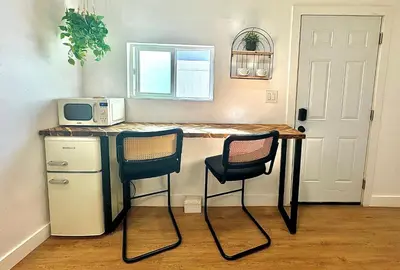 a kitchen with a table with two chairs and a microwave at *Golden Getaway* 5 Beds / 8 Minutes to Downtown in San Diego