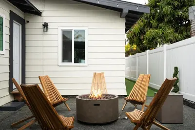 three chairs and a fire pit in front of a house at *Golden Getaway* 5 Beds / 8 Minutes to Downtown in San Diego