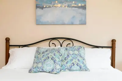 a bed with a pillow on top of it at Casa Amore -2BR- FREE Driveway parking for 3 cars in San Diego