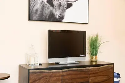 a television sitting on top of a wooden cabinet at Casa Amore -2BR- FREE Driveway parking for 3 cars in San Diego