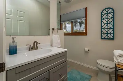 a bathroom with a sink and a toilet at Cozy Family Getaway home in Carlsbad