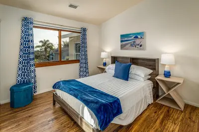 a bedroom with a large bed and a window at Cozy Family Getaway home in Carlsbad