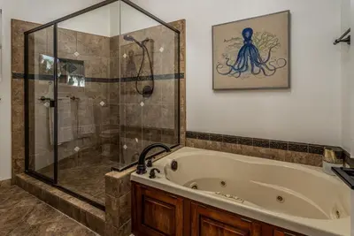 a bathroom with a tub and a shower at Cozy Family Getaway home in Carlsbad