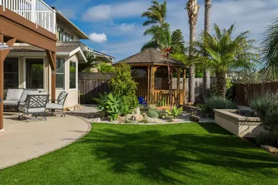 a backyard with a lawn and a gazebo at Cozy Family Getaway home in Carlsbad