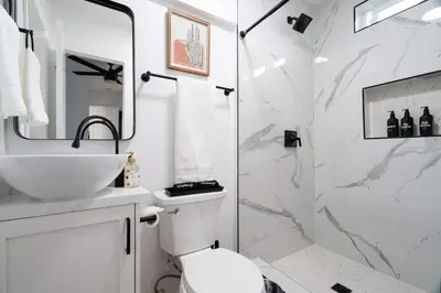 a bathroom with a toilet and a sink and a shower at * Bueno Bueno Casita * / 7 min to Downtown / 4 Bdr in San Diego