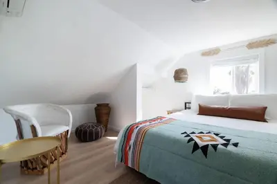 a bedroom with a bed and a table and a chair at * Bueno Bueno Casita * / 7 min to Downtown / 4 Bdr in San Diego