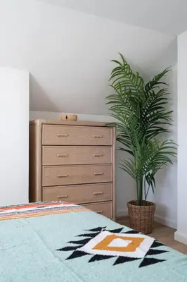 a bedroom with a dresser and a potted plant at * Bueno Bueno Casita * / 7 min to Downtown / 4 Bdr in San Diego