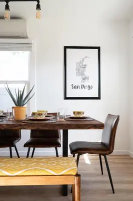 a dining room with a wooden table and chairs at * Bueno Bueno Casita * / 7 min to Downtown / 4 Bdr in San Diego