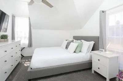 a white bedroom with a bed and a window at 3 Bedroom 2 Bath House with Parking - 10 Guests in San Diego