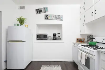 a kitchen with white appliances and a white refrigerator at 3 Bedroom 2 Bath House with Parking - 10 Guests in San Diego