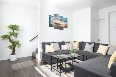 a living room with a couch and a table at 3 Bedroom 2 Bath House with Parking - 10 Guests in San Diego