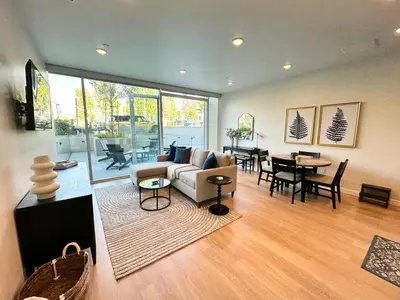 a living room with a couch and a table at Nimitz Crossing Luxury Residences in San Diego