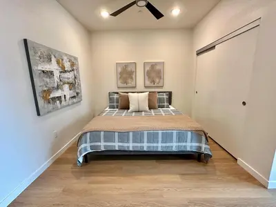 a bedroom with a bed and a ceiling fan at Nimitz Crossing Luxury Residences in San Diego