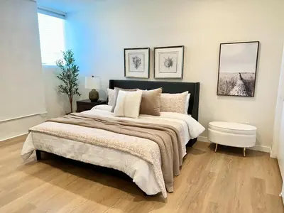a bedroom with a large bed and two pictures on the wall at Nimitz Crossing Luxury Residences in San Diego