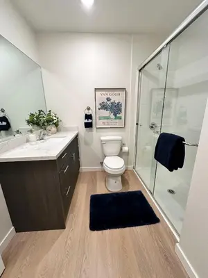 a bathroom with a toilet sink and a shower at Nimitz Crossing Luxury Residences in San Diego