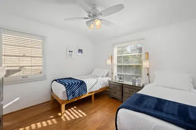 a bedroom with a bed and a ceiling fan at Sea Side Beauty in San Diego