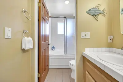 a bathroom with a sink and a fish on the wall at Pine Street #2 in Oceanside