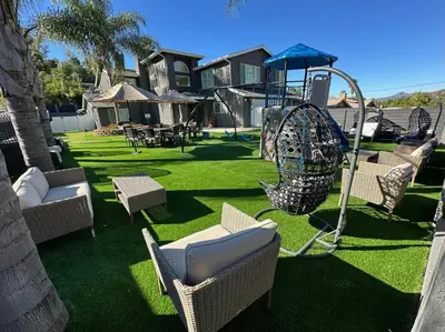 a yard with a playground with chairs and a swing at Luxury Resort•POOL/SPA/Golf/Grill/Games/Sleep 40+ in Lakeside