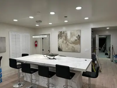 a kitchen with a large white island with black chairs at Luxury Resort•POOL/SPA/Golf/Grill/Games/Sleep 40+ in Lakeside