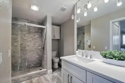 a bathroom with a white sink and a shower at Oceanfront 1BR, Fully Furnished, Gated Parking in Oceanside