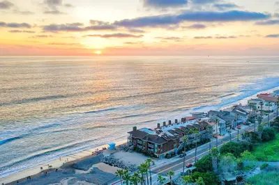 an aerial view of the beach at sunset at Oceanfront 1BR, Fully Furnished, Gated Parking in Oceanside