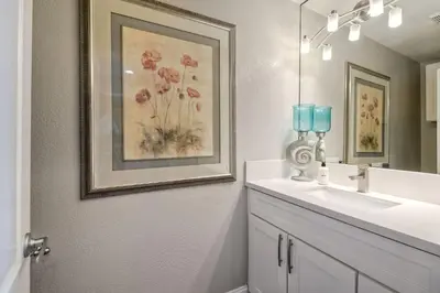 a bathroom with a sink and a picture on the wall at Oceanfront 1BR, Fully Furnished, Gated Parking in Oceanside