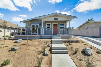 a small white house with a red door at San Diego Heights - Urban Legend in San Diego
