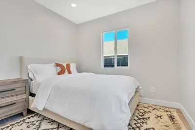 a white bedroom with a bed and a window at San Diego Heights - Urban Legend in San Diego