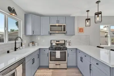 a kitchen with blue cabinets and a stove top oven at San Diego Heights - Urban Legend in San Diego