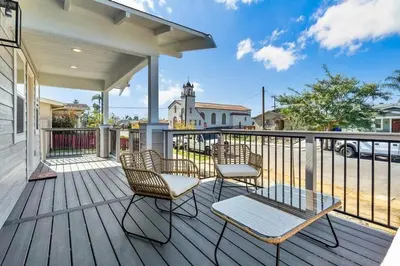 a porch with chairs and a table and a fence at San Diego Heights - Urban Legend in San Diego
