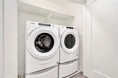 a washer and dryer in a white laundry room at King Size, Patio, Xbox, Great Park in Irvine