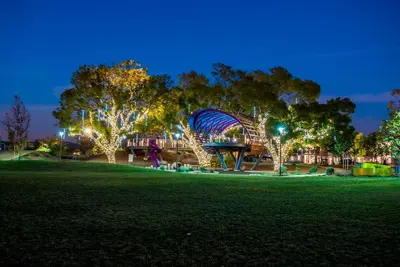 a roller coaster in a park at night at King Size, Patio, Xbox, Great Park in Irvine