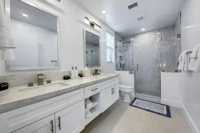 a white bathroom with two sinks and a shower at An Architectural masterpiece with unparalleled beauty, elegance and amenities in Temecula