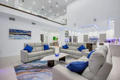 a large living room with couches and blue pillows at An Architectural masterpiece with unparalleled beauty, elegance and amenities in Temecula