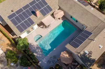 an overhead view of a swimming pool with solar panels at Stunning 4 Bedroom 1 Level- Pool, Spa, Grass Yard, Fire Pit, Garage, BBQ in Mission Viejo