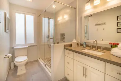 a bathroom with a toilet and a shower and a sink at Stunning 4 Bedroom 1 Level- Pool, Spa, Grass Yard, Fire Pit, Garage, BBQ in Mission Viejo
