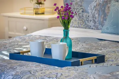 a blue tray with two cups and a vase with flowers at Stunning 4 Bedroom 1 Level- Pool, Spa, Grass Yard, Fire Pit, Garage, BBQ in Mission Viejo