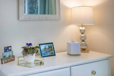 a white dresser with a lamp on top of it at Stunning 4 Bedroom 1 Level- Pool, Spa, Grass Yard, Fire Pit, Garage, BBQ in Mission Viejo