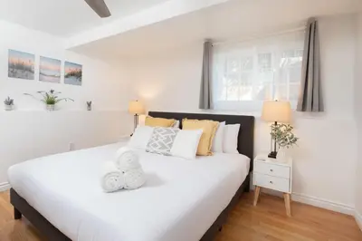 a bedroom with a large white bed with yellow pillows at 3 Bedroom with Ocean View Jacuzzi and Parking in San Diego