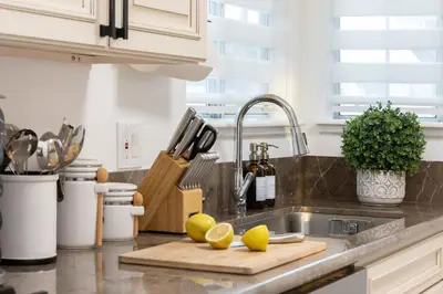 a kitchen with a sink with lemons on a cutting board at 3 Bedroom House - Fire Pit Table BBQ - 10 Guests in La Mesa