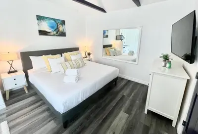a bedroom with a large bed and a mirror at Hidden King Suite with Garden Parking - 4 Guest in La Mesa