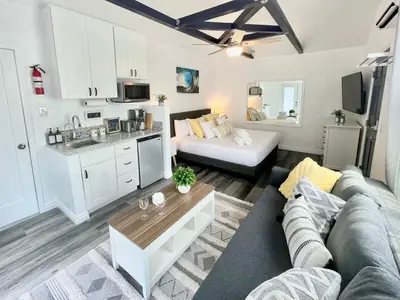 a living room with a couch and a kitchen at Hidden King Suite with Garden Parking - 4 Guest in La Mesa