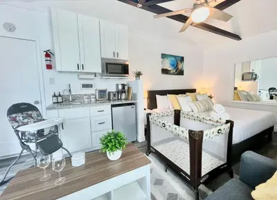 a living room with a bed and a kitchen with a table at Hidden King Suite with Garden Parking - 4 Guest in La Mesa