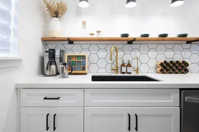 a kitchen with white cabinets and a sink at 2 Bedroom House - Fire Pit Table BBQ - Downtown in San Diego